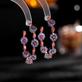 2025 Korean version of fashionable retro earrings, cold wind personality, black bottom circle, colored zircon silver needle earrings, flower earrings.