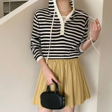 Hooded drawstring bottoming shirt women's spring new design versatile T-shirt V-neck shell buckle fake two-piece long-sleeved top