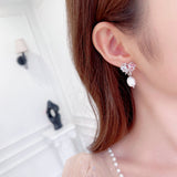 2025 S925 silver needle high-end earrings women's simple fashion sweet temperament love bow baroque pearl stud earrings