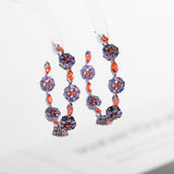 2025 Korean version of fashionable retro earrings, cold wind personality, black bottom circle, colored zircon silver needle earrings, flower earrings.