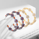 2025 Korean version of fashionable retro earrings, cold wind personality, black bottom circle, colored zircon silver needle earrings, flower earrings.