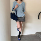 Hooded drawstring bottoming shirt women's spring new design versatile T-shirt V-neck shell buckle fake two-piece long-sleeved top