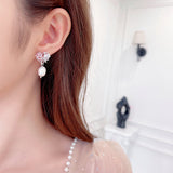 2025 S925 silver needle high-end earrings women's simple fashion sweet temperament love bow baroque pearl stud earrings