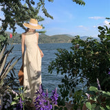 2025 Seaside niche design sense hollow waist hanging neck suspender dress women's summer waist thin fringed long skirt